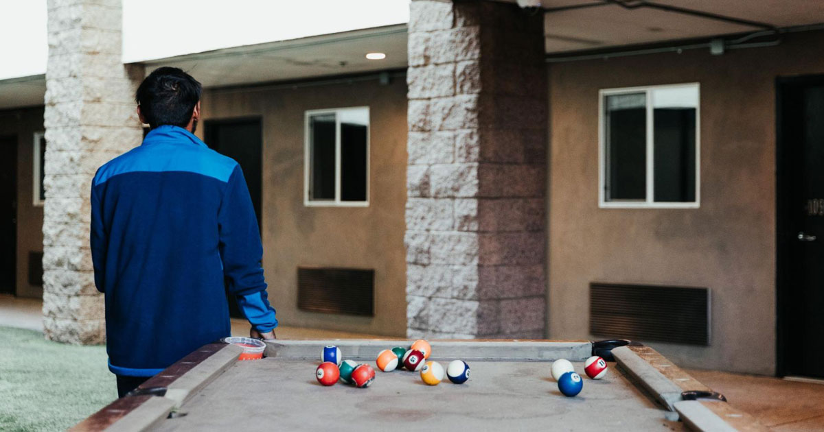 Patient Standing Beside Pool Table at Detox Facility