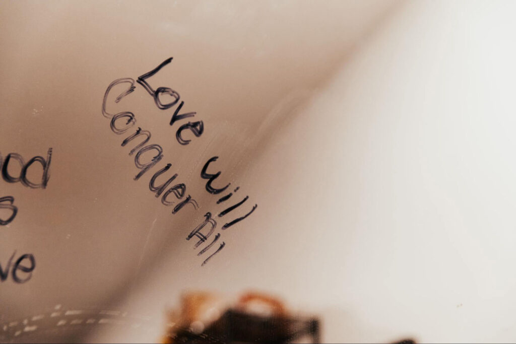 Love Will Conquer Written on Mirror