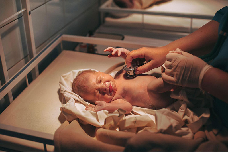 Doctor Treating Newborn Baby