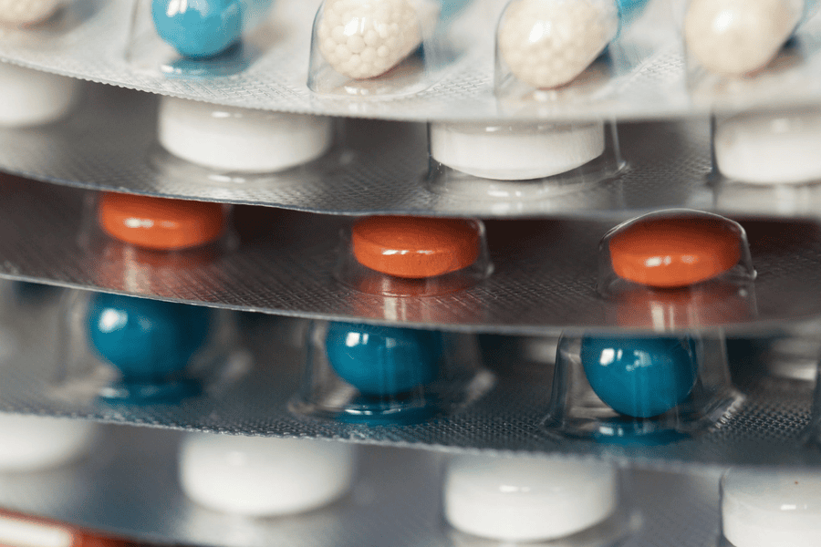 Blister packs of various prescription medications, representing FDA-approved treatments for opioid addiction.