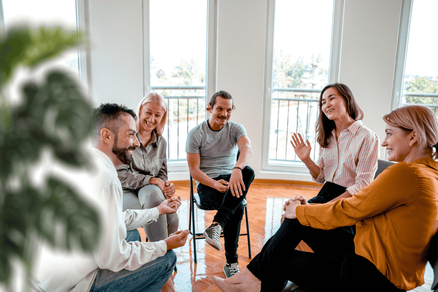 Group therapy session at Axiom Care, where individuals in recovery share experiences and offer mutual support in a positive environment