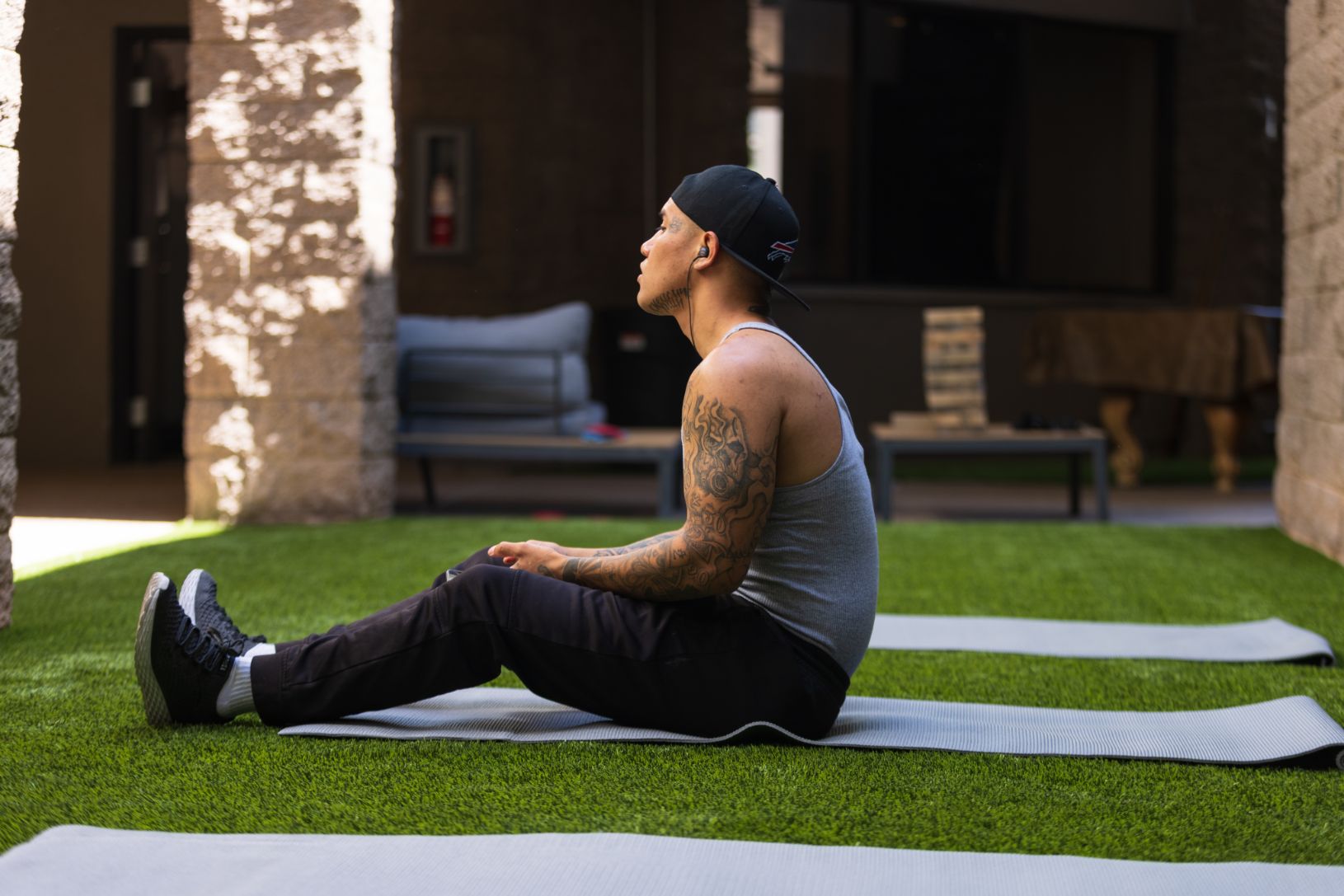 Man on a yoga mat in a garden during his recovery journey at an AXIOM Recovery Center