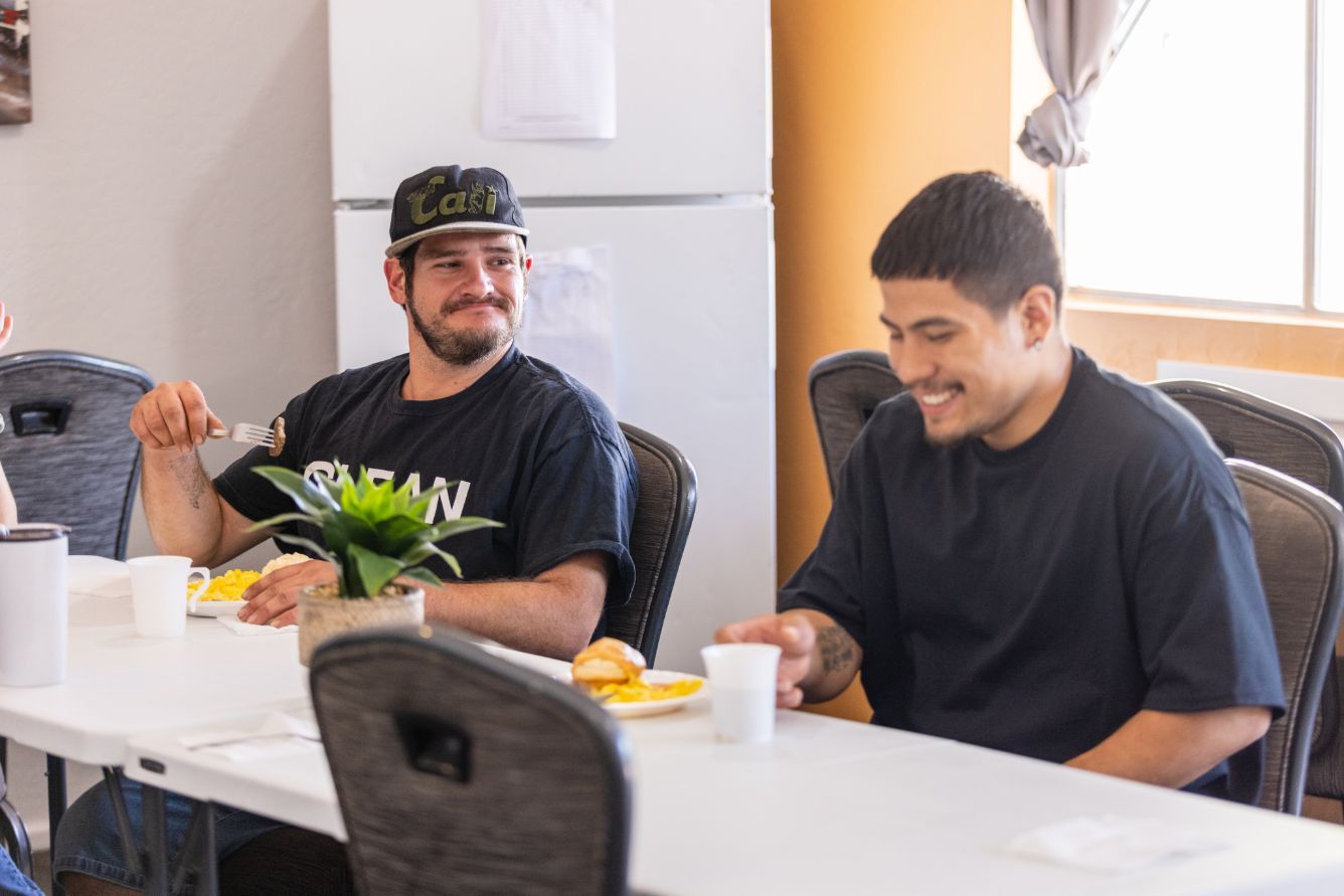 Two men smiling and having a good time at an AXIOM Recovery Center